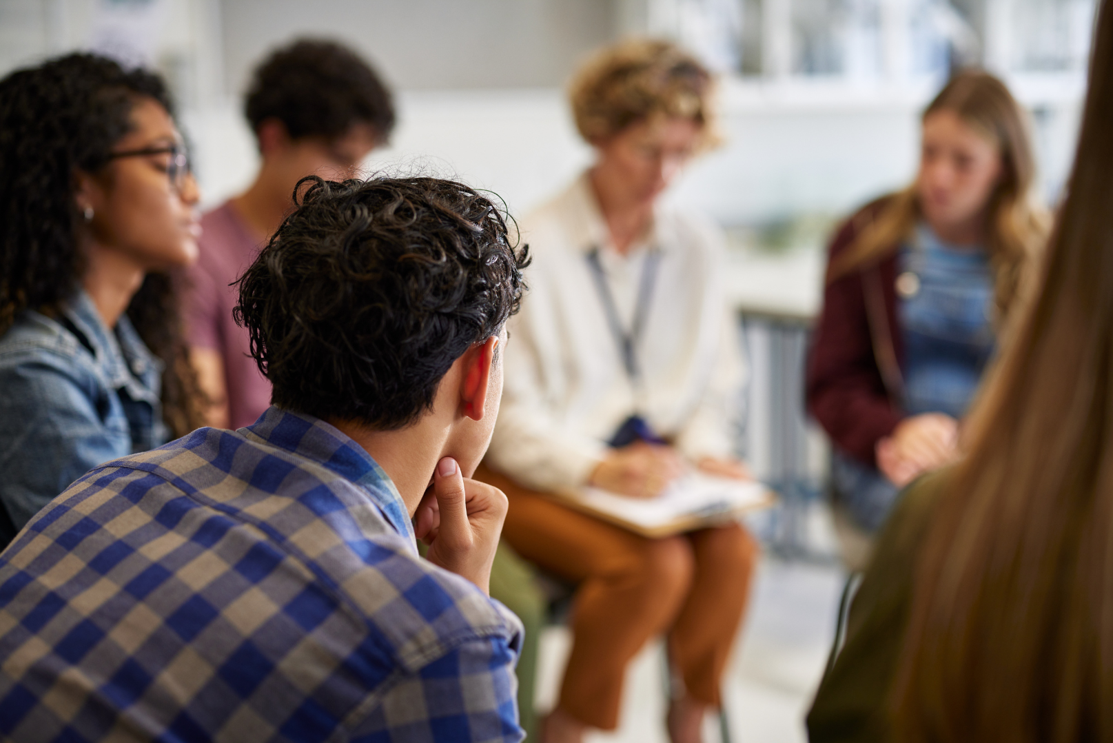 Picture of people sitting on chairs in a circle